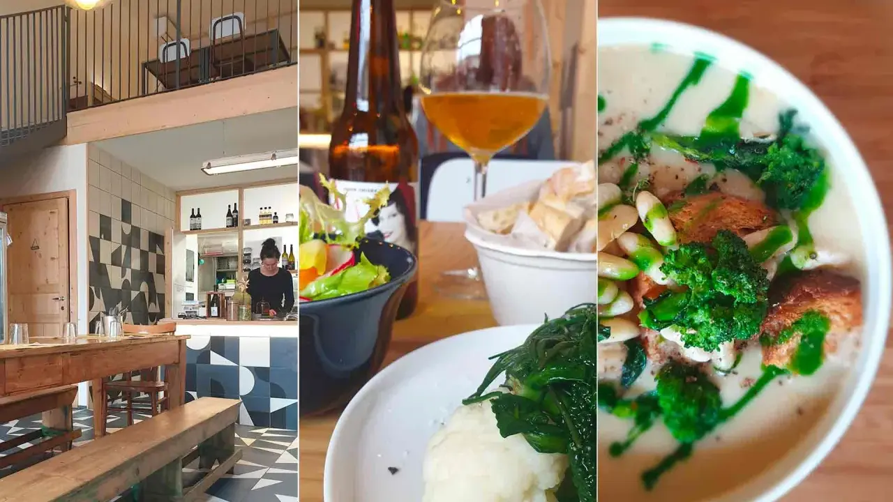 Interno di una trattoria a Rimini centro: tavoli in legno, bancone, insalata, birra e zuppa.