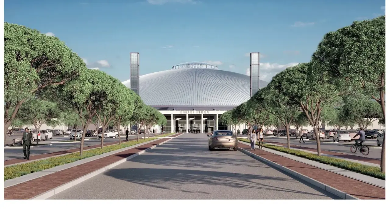 Ingresso ovest della fiera di Rimini, con viali alberati, parcheggi e un'imponente cupola.