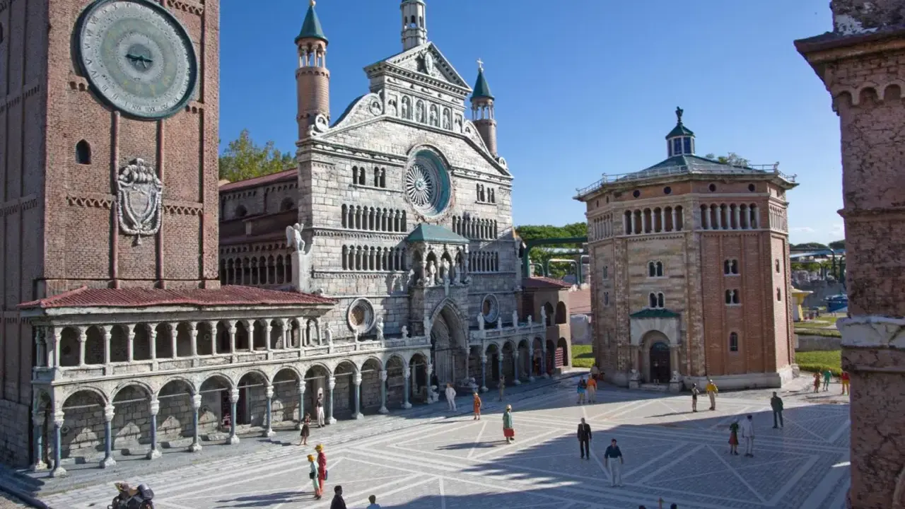 Miniature Italian landmarks, including a cathedral and a clock tower, with tiny people in a plaza.
