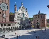 Miniature Italian landmarks, including a cathedral and a clock tower, with tiny people in a plaza.