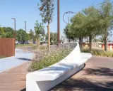 Passeggiata moderna con panchina bianca e fiori sulla bellariva di Rimini.