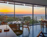 Tavoli apparecchiati in un ristorante con vista sul tramonto sul mare. Un'atmosfera magica per i ristoranti a Gabicce Monte.