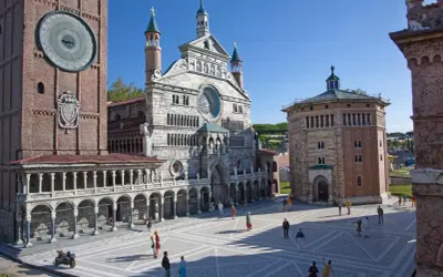 Miniature Italian landmarks, including a cathedral and a clock tower, with tiny people in a plaza.