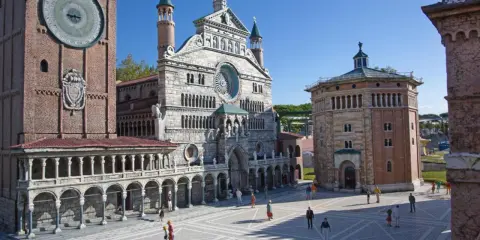 Miniature Italian landmarks, including a cathedral and a clock tower, with tiny people in a plaza.