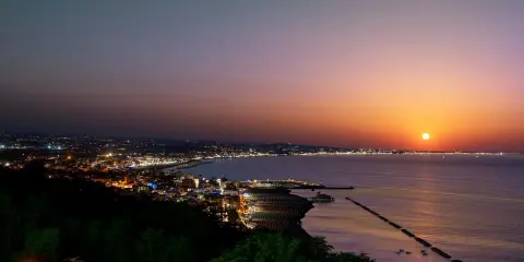 Tramonto su Gabicce Mare. Luci della città accese, un invito a scoprire cosa fare a Gabicce Mare la sera, tra passeggiate sul lungomare e cene vista mare.