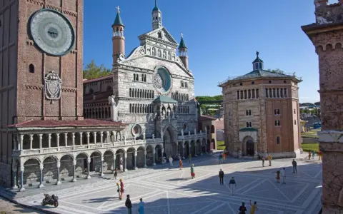 Miniature Italian landmarks, including a cathedral and a clock tower, with tiny people in a plaza.