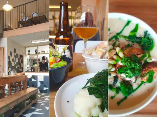 Interno di una trattoria a Rimini centro: tavoli in legno, bancone, insalata, birra e zuppa.