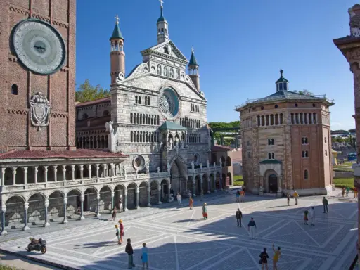 Miniature Italian landmarks, including a cathedral and a clock tower, with tiny people in a plaza.