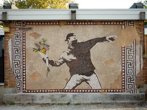 IconosaiK project: street art a Ravenna con un mosaico che raffigura un uomo lancia fiori, un messaggio di pace.