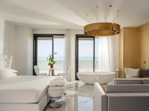 Lussuosa camera con vista mare, perfetta per un soggiorno in un b&b Riviera Romagnola. Letto king, vasca freestanding e arredi eleganti.