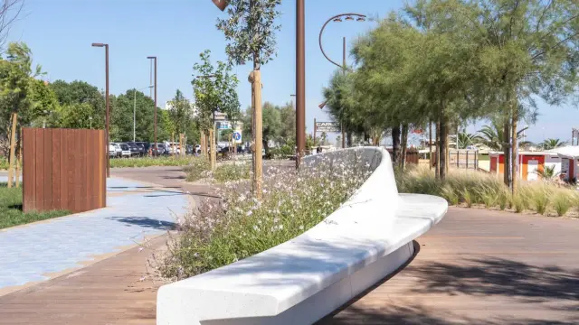 Passeggiata moderna con panchina bianca e fiori sulla bellariva di Rimini.
