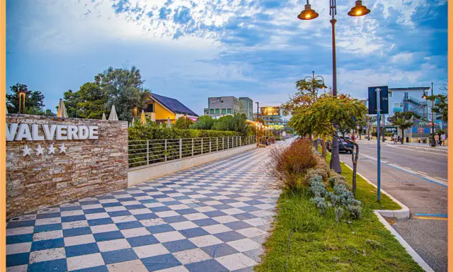 Passeggiata serale sul lungomare Valverde di Cesenatico, con il suo caratteristico pavimento a scacchi e le luci soffuse.