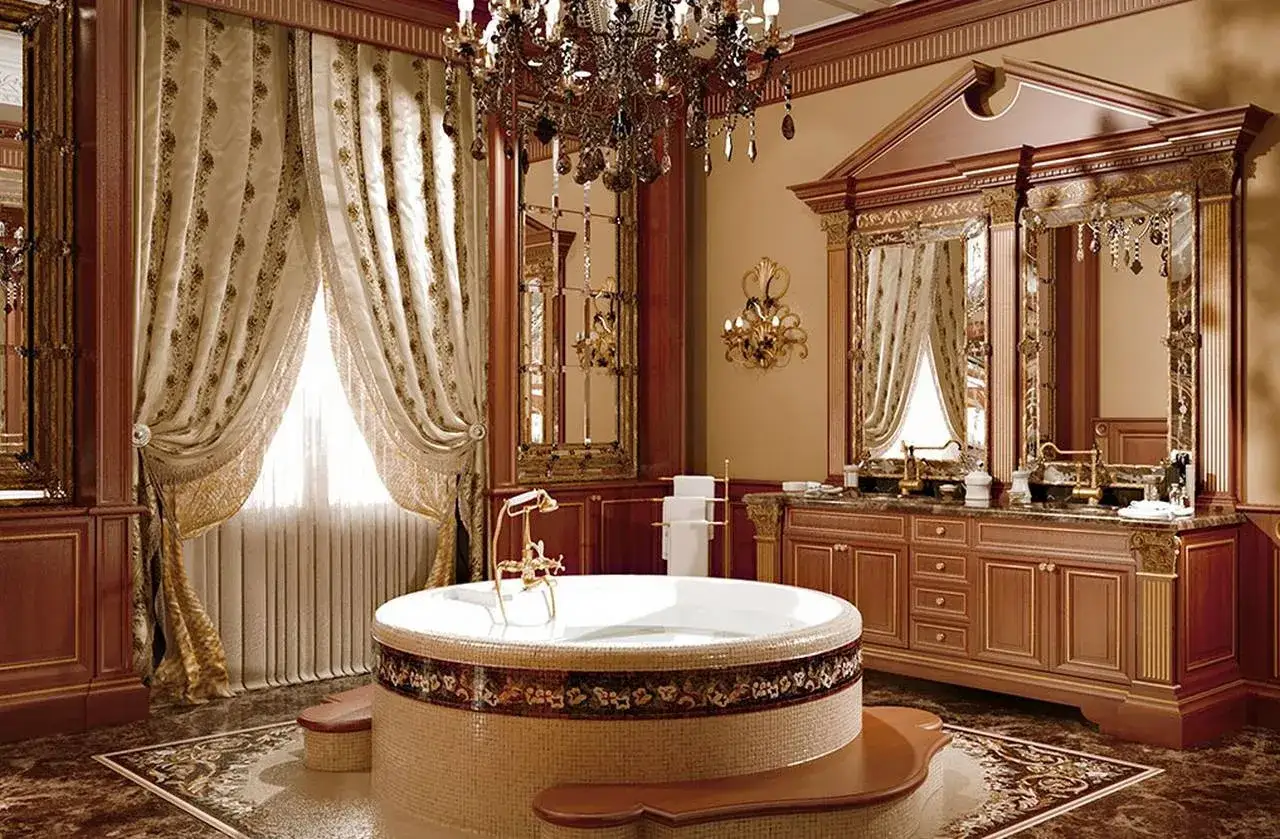 Un bagno da sogno, tra i bagni più belli ed eleganti, con vasca tonda in mosaico, doppio lavabo in legno e specchi dorati.